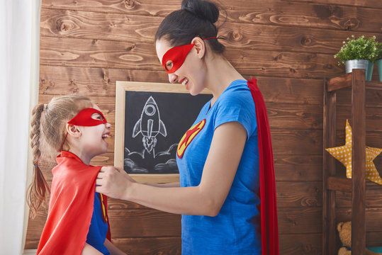 Girl and mom in Superhero costumes