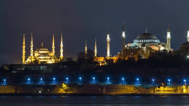 Hagia Sophia and Blue Mosque timelapse at night reflected in Bosphorus water. Istanbul, Turkey