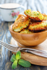 Wooden bowl with fritters made from zucchini.