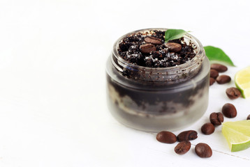 
Cosmetic matte glass jar of coffee grounds natural scrub mixed with sugar, beans and lime scented. Side copyspace. 