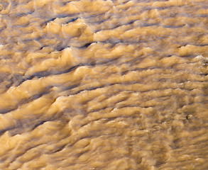 Dirty water in a stormy river as a background