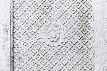 Texture of handmade carving white wooden wall in Bali house. Traditional indonesian style