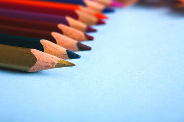 Wooden colorful pencils in row, close-up