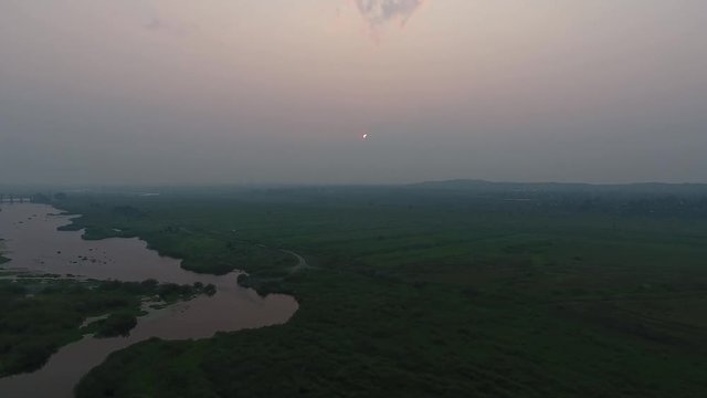 Aerial View. Panoramic summer morning landscape. The picturesque landscape with river, trees and field with Incredible sun. Morning Fog.