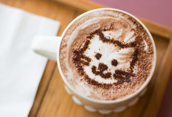 Coffee cup with artistic cream cat face decoration