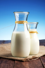 milk products - tasty healthy dairy products on a table on: and milk jar, glass bottle and in a glass