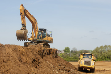 Excavator preparing earth for industrial property development