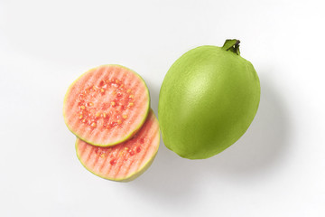 Fresh halves pink guava isolated on white background