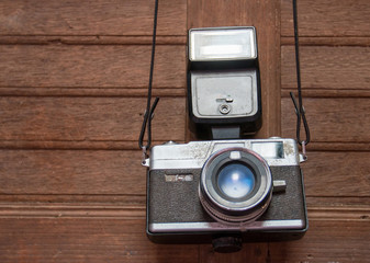 old vintage camera hang on a wood wall