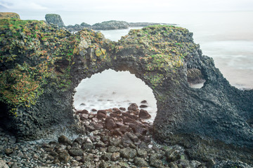 Gatklettur or rock with a hole, is located in the Snaeffellsnes peninsula of West Iceland. The Gatklettur results of actions of ocean waves, eroding rock formation of a coastline into an arched rock.