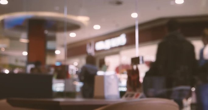 People shopping in department store. Defocused blur background footage.