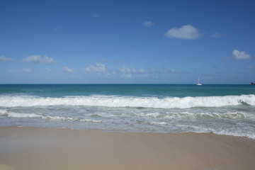 Fototapeta na wymiar Beach scene Antigua, showing sand, sea and blue sky