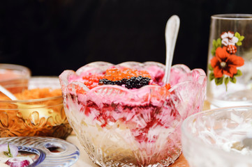 Beet salad in a vase on a table, red and black caviar. Close-up, selective focus.