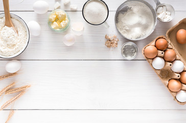 Baking ingredients on white rustic wood background, copy space © Prostock-studio