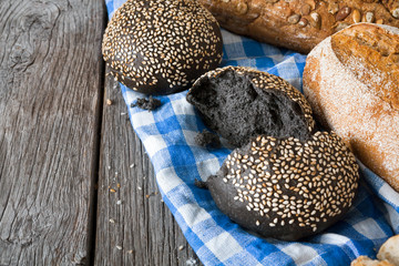 Black bread background with copy space on rustic wood