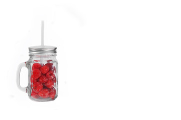 Raspberries in a glass with straw tube