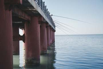 fishing on the bridge at the sea
