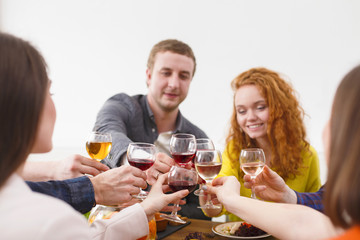 Group of happy young people at dinner table, friends party