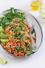 
    Tabbouleh.Traditional bulgur salad with vegetables and herbs. Selective focus