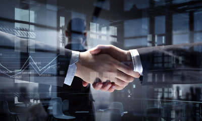 Partners shaking hands as symbol of deal