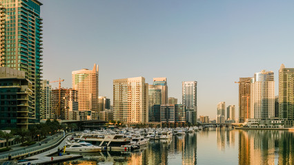 Fototapeta na wymiar Dubai. In the summer of 2016. Construction of modern skyscrapers in Dubai Marina on the shore of the Arabian Gulf. 