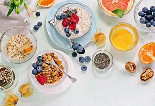 
    Breakfast table with granola, fresh smoothie, juice and various of sandwiches. Healthy eating concept 