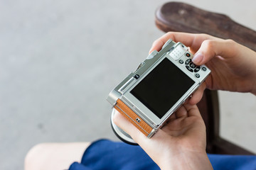 View of hand holding camera with clear black LCD screen