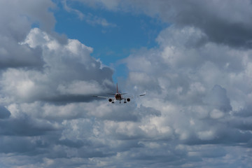 Fototapeta na wymiar Flugzeug Landung auf dem Hintergrund des bewölkten Himmels