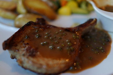 Selective focus of beef steak with green peppers