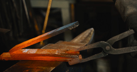 Rod hot iron on the anvil.