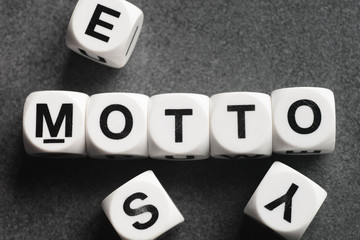 word motto on toy cubes