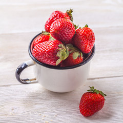 Strawberries in an enameled cup