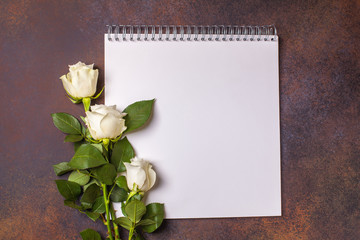 White notepad on a brown background, copyspace, horizontal