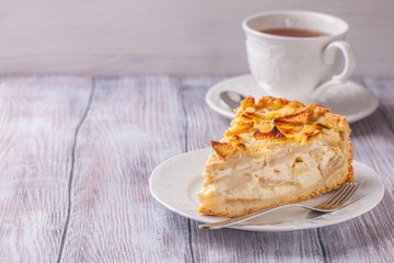 Apple pie, tea in a white cup, horizontally