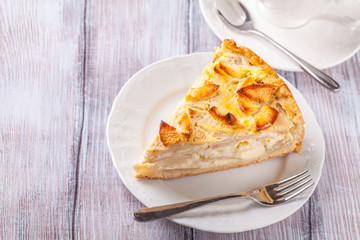 Apple pie, tea in a white cup, horizontally