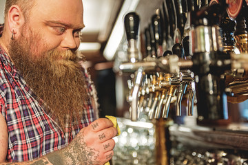 Man cleaning equipment in alehouse