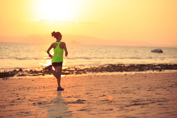 Fototapeta na wymiar Healthy lifestyle young fitness woman running at morning beach