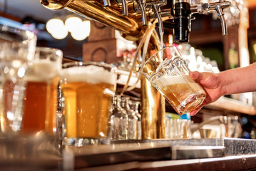 Man hand filling glass of alcohol beverage