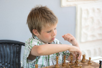 Portrait of a boy playing chess