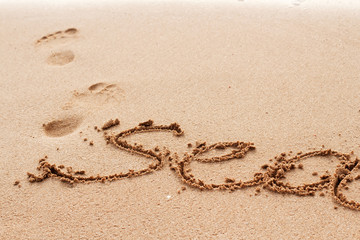 Sea word handwritten on the sand