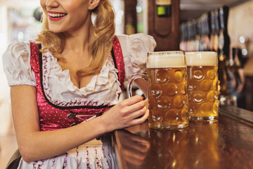Outgoing woman tasting alcohol in tap-room