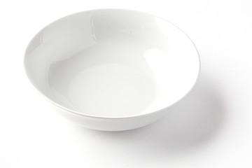 White wide salad bowl from side on a white background