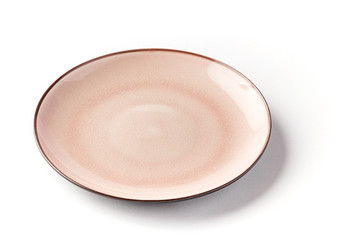 Pink and white round broken textured plate from top on a white background