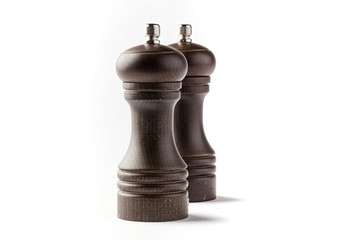 Wooden pepper and salt grinder on a white background