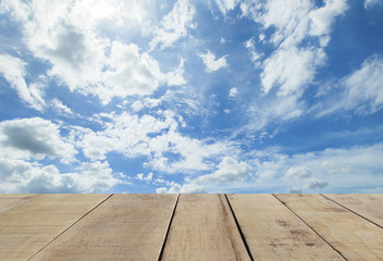 wooden plank with wooden plank with panorama shot of blue sky and clouds