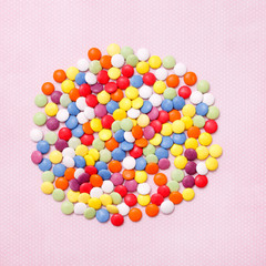 lollipops, candy, top view flat lay on pink background