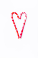 Pattern candy cane on white background, top view flat lay. Sweet sucker, lollipop, candy, isolated minimal concept above decoration, food background