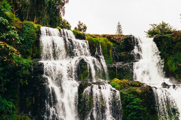 Fototapeta premium The view of majestic Tad Fane waterfall. Situated in Dong Houa Sao National Protected Area, Bolaven Plateau, Champasak Province, Laos The water drops about 120 m.