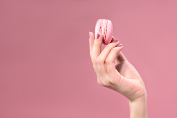 Tasty small cake in woman hand