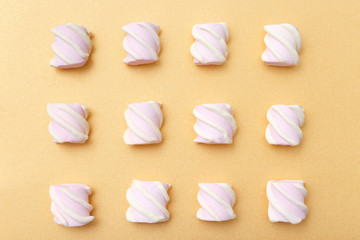 Pattern sweet marshmallow, candy on gold background, top view flat lay. Isolated minimal concept above decoration, food background